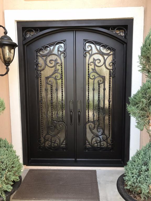 A close-up of a beautiful double entry iron door.