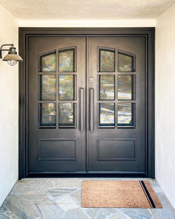 A close-up of a beautiful wrought Iron Door placed on the home entryway.