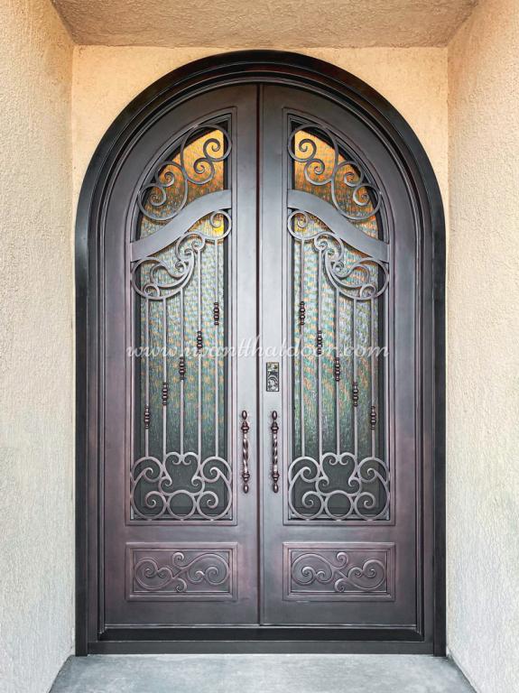 A close-up of a beautiful iron door is installed on the house door.